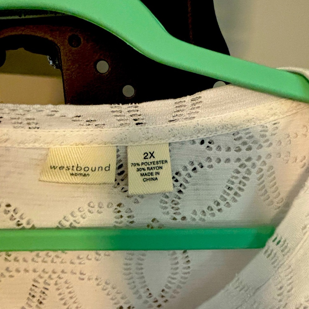 Eyelet top.No spots or stains.Smoke free home.Asymmetrical blouse.Gently worn.